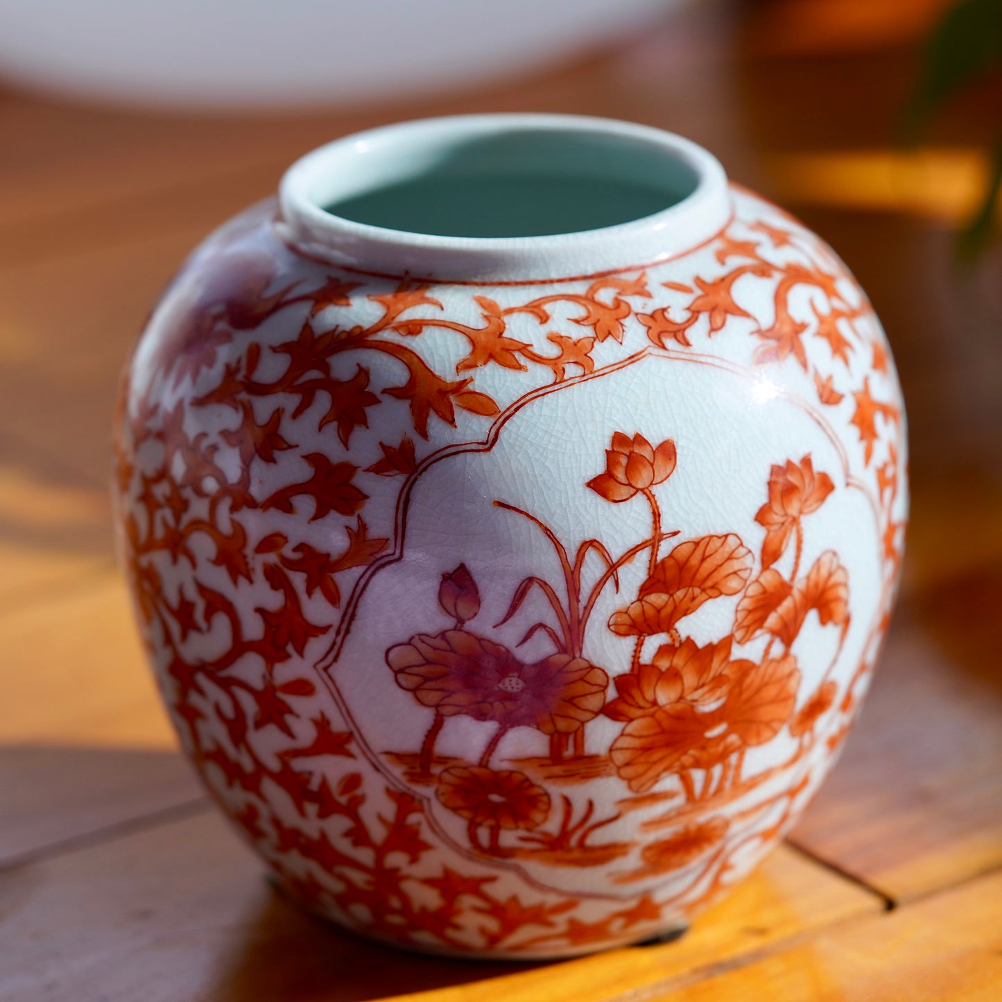 Load image into Gallery viewer, Left side of vintage white and orange handpainted Japanese porcelain vase with flowers, displayed on light wood floor.
